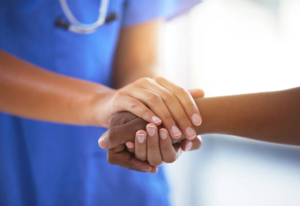 Doctor holding patient’s hand